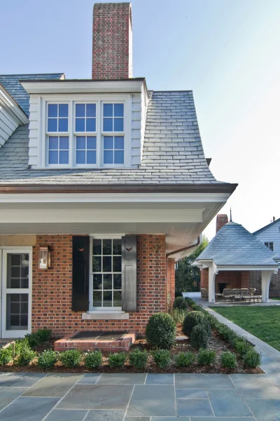 Dutch Colonial Renovation side view with outdoor kitchen
