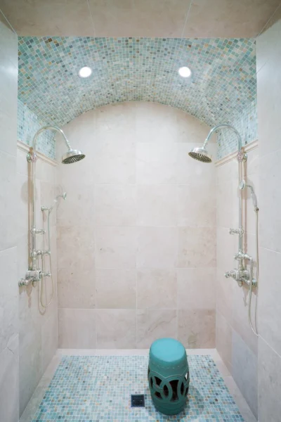 shower with double shower heads blue tiles
