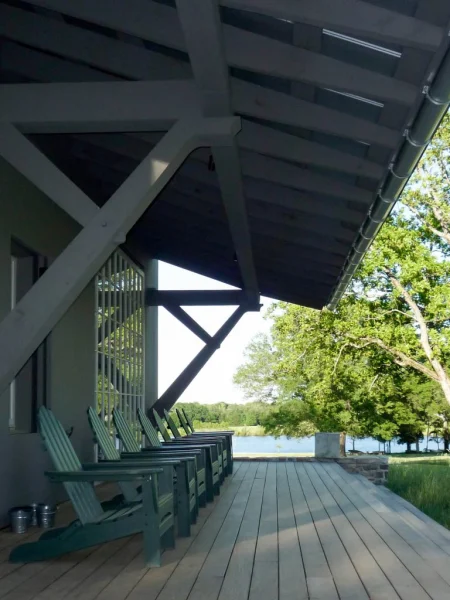 porch with eight chairs near the lake