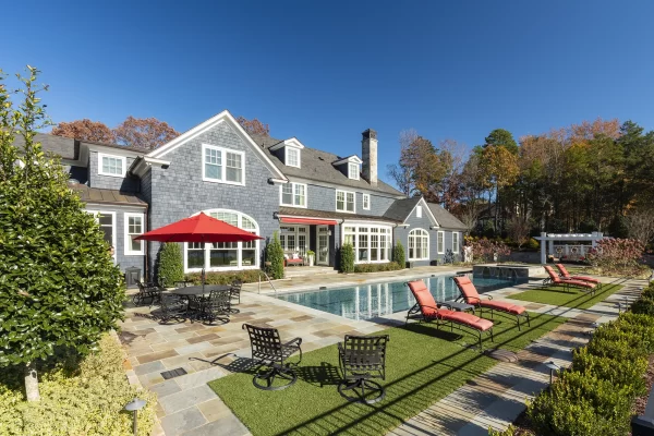 blue siding home with lap pool exterior